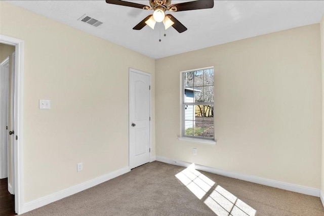 spare room featuring light carpet and ceiling fan