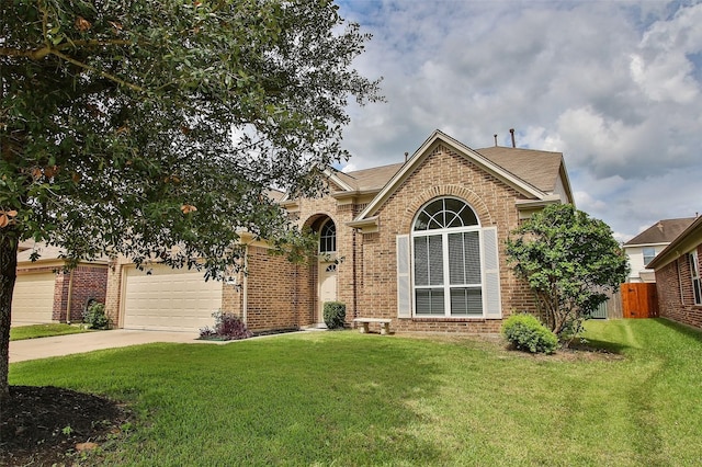 view of front of property with a garage and a front lawn