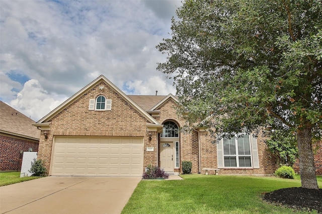 front facade featuring a garage and a front lawn