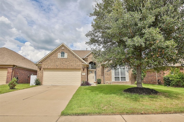 view of front of property featuring a front yard and a garage