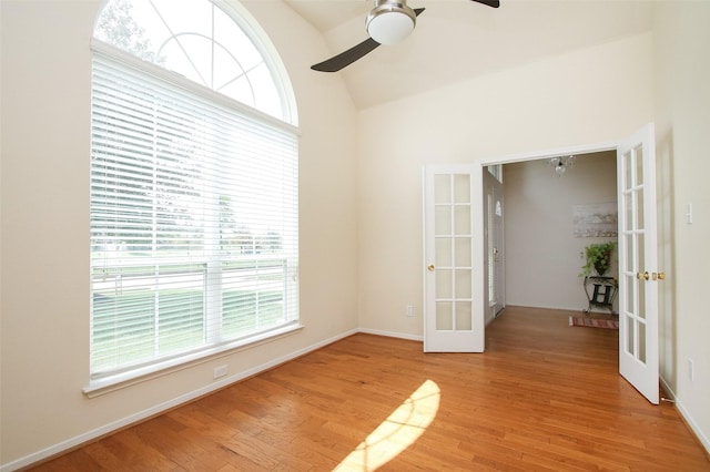 unfurnished room featuring french doors, light hardwood / wood-style floors, vaulted ceiling, and ceiling fan