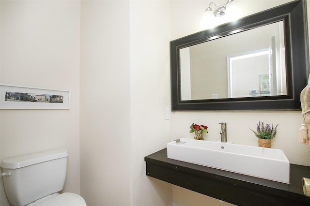 bathroom featuring toilet and sink