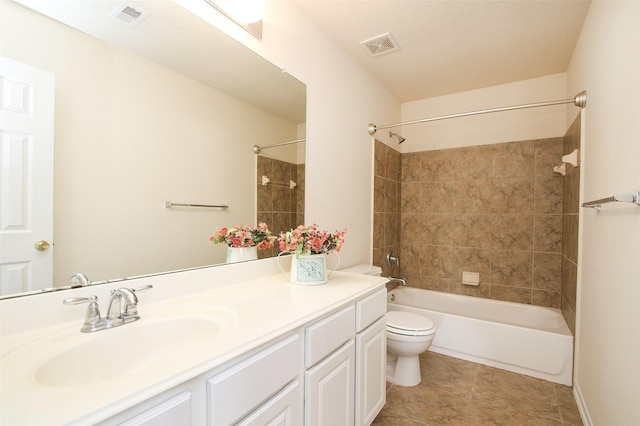 full bathroom with tile patterned flooring, vanity, toilet, and tiled shower / bath