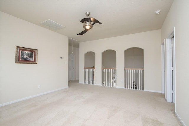 spare room featuring light carpet and ceiling fan