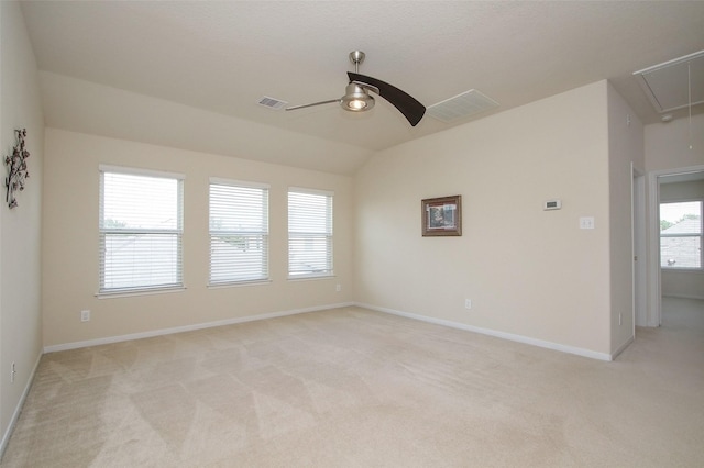 carpeted empty room featuring ceiling fan and lofted ceiling