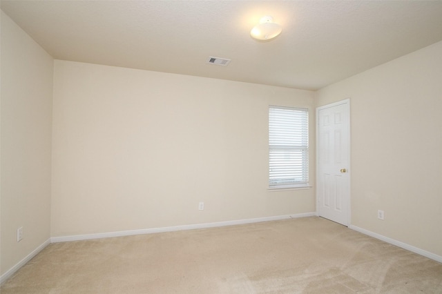 unfurnished room with light colored carpet