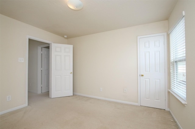 unfurnished bedroom featuring light colored carpet