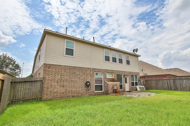 rear view of house featuring a yard