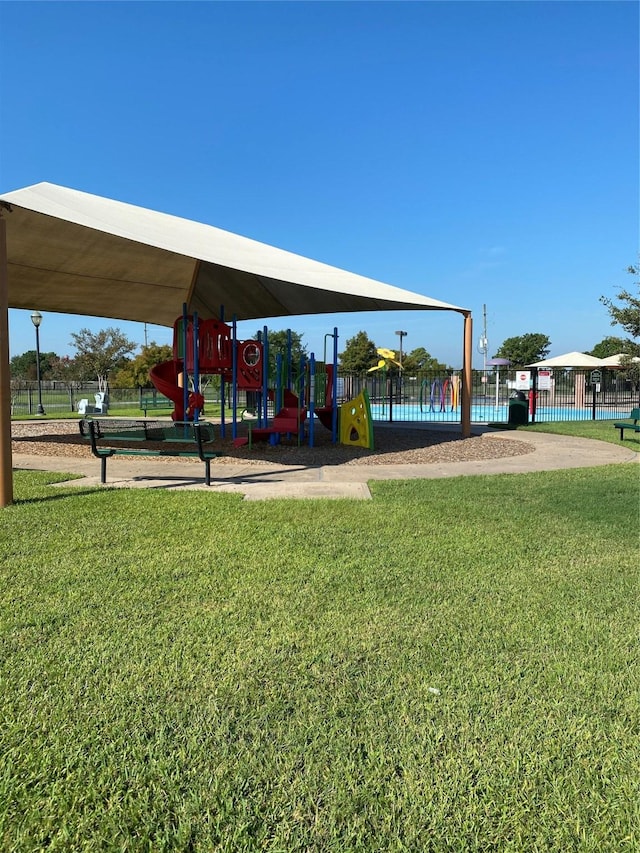 view of home's community with a yard and a playground