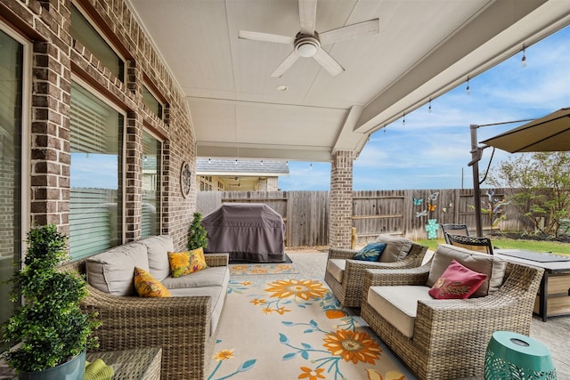 view of patio with an outdoor living space, area for grilling, and ceiling fan