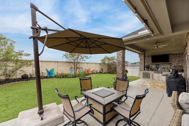 view of patio with area for grilling and ceiling fan