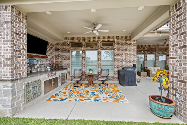 view of patio / terrace with an outdoor kitchen and ceiling fan