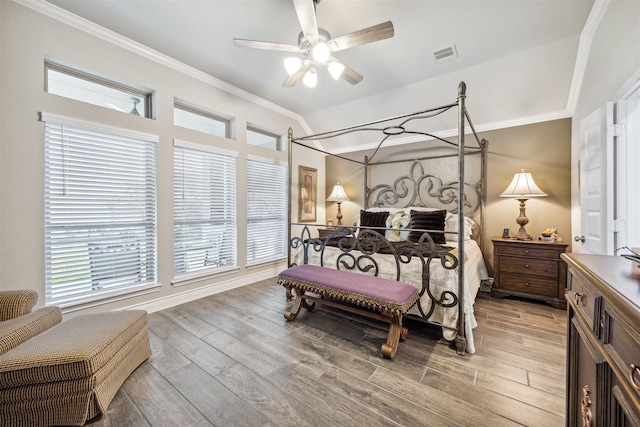 bedroom featuring light hardwood / wood-style flooring, ceiling fan, and crown molding