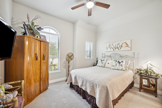 bedroom featuring light carpet and ceiling fan