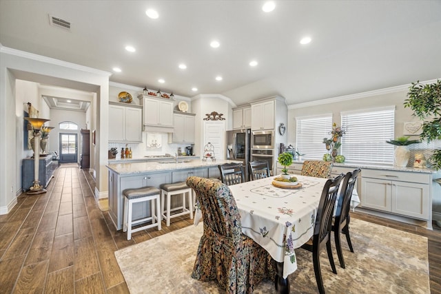 dining room featuring crown molding