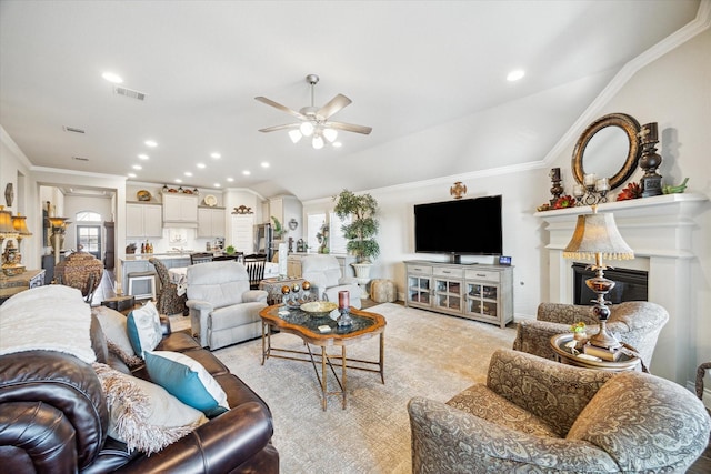 living room with crown molding, ceiling fan, and lofted ceiling