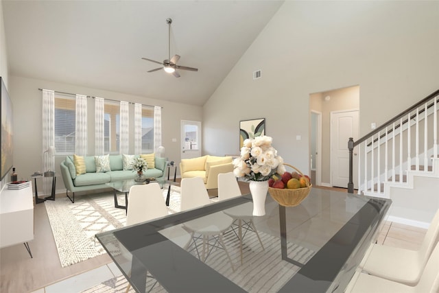 living room with ceiling fan, high vaulted ceiling, and light tile patterned floors