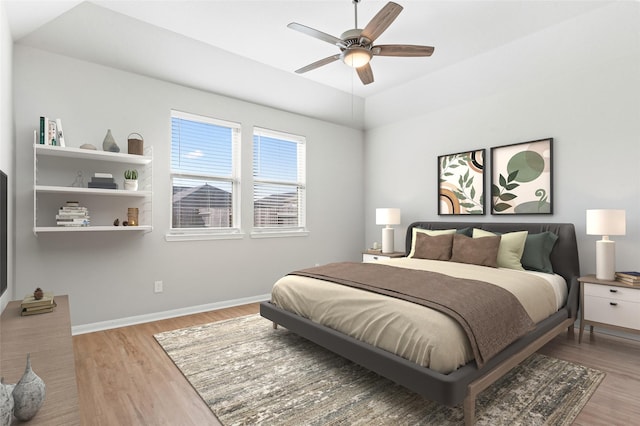 bedroom with ceiling fan and light hardwood / wood-style flooring