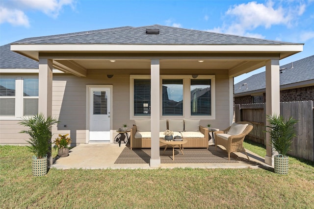 rear view of house featuring an outdoor hangout area, a patio area, and a lawn