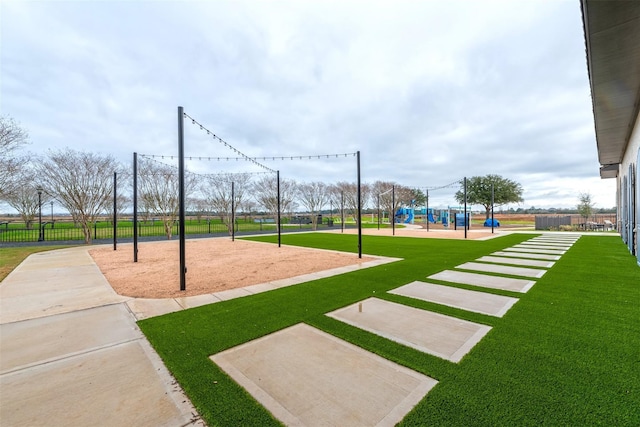 view of home's community with a yard and a playground