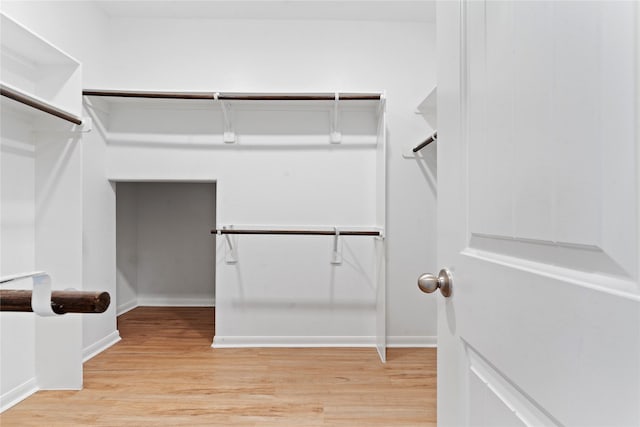 spacious closet featuring light hardwood / wood-style floors