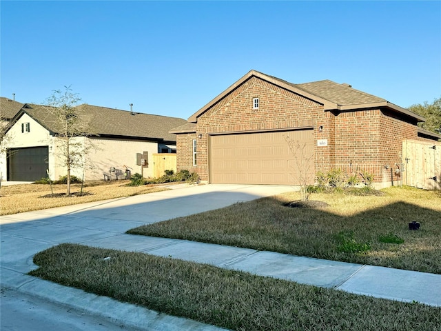 view of front of property with a garage and a front lawn