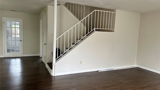 stairway featuring wood-type flooring and a textured ceiling