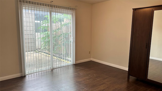 spare room with dark hardwood / wood-style floors