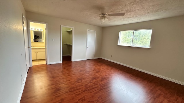 7204 Crownwest St Unit 7204, Houston, TX 77072 - unfurnished bedroom featuring baseboards, a ceiling fan, wood finished floors, and connected bathroom