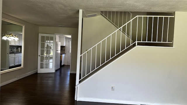 7204 Crownwest St Unit 7204, Houston, TX 77072 - stairs featuring baseboards, visible vents, a textured ceiling, and wood finished floors