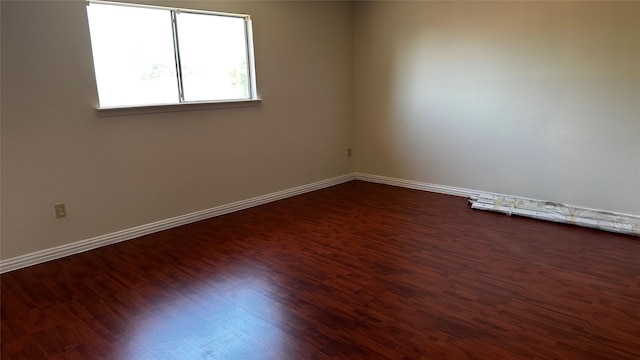 7204 Crownwest St Unit 7204, Houston, TX 77072 - spare room with baseboards and dark wood-style floors