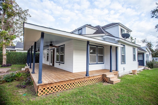 exterior space with ceiling fan, a wooden deck, and a yard