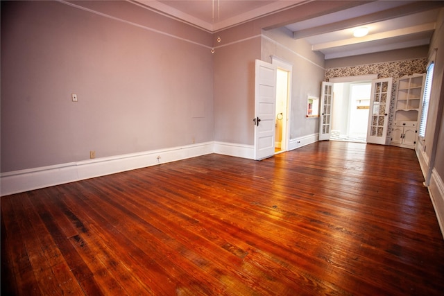 spare room with built in shelves and dark hardwood / wood-style floors