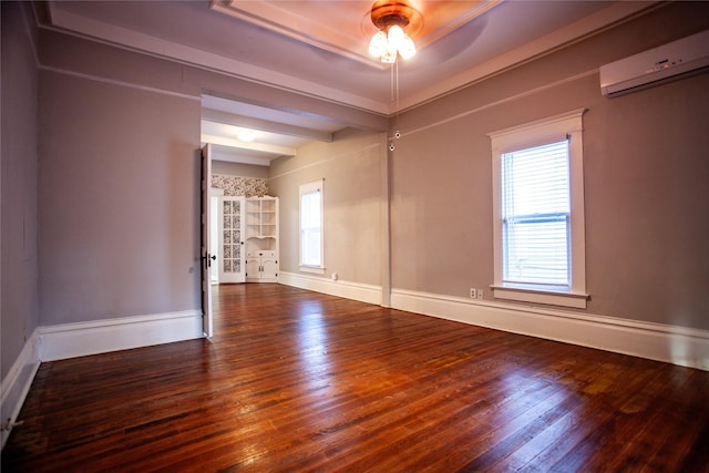 unfurnished room featuring hardwood / wood-style flooring and an AC wall unit