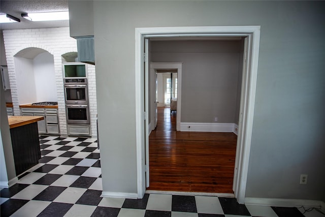 hall featuring a textured ceiling