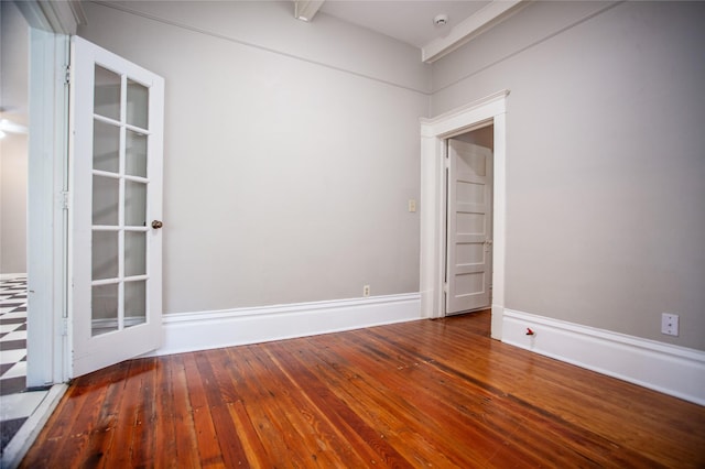 unfurnished room featuring beam ceiling and wood-type flooring