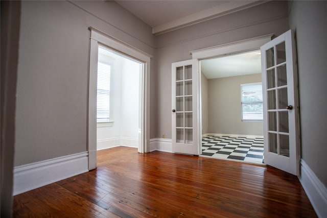 empty room with french doors and dark wood-type flooring