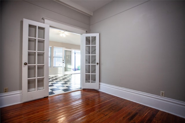 unfurnished room with hardwood / wood-style flooring and french doors