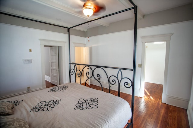 bedroom featuring ceiling fan, wood-type flooring, and beam ceiling