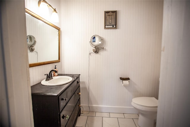 bathroom featuring toilet, tile patterned floors, and vanity