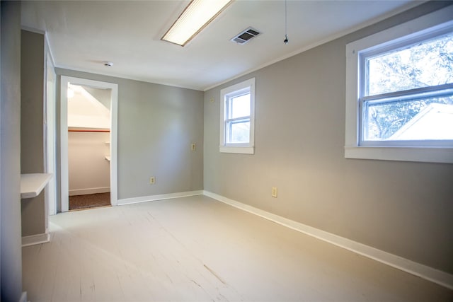 interior space featuring a spacious closet, a closet, and crown molding