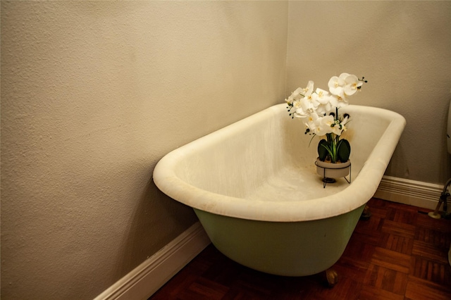 details featuring a washtub and parquet flooring