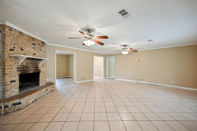 unfurnished living room with ceiling fan, ornamental molding, a textured ceiling, a fireplace, and light tile patterned floors