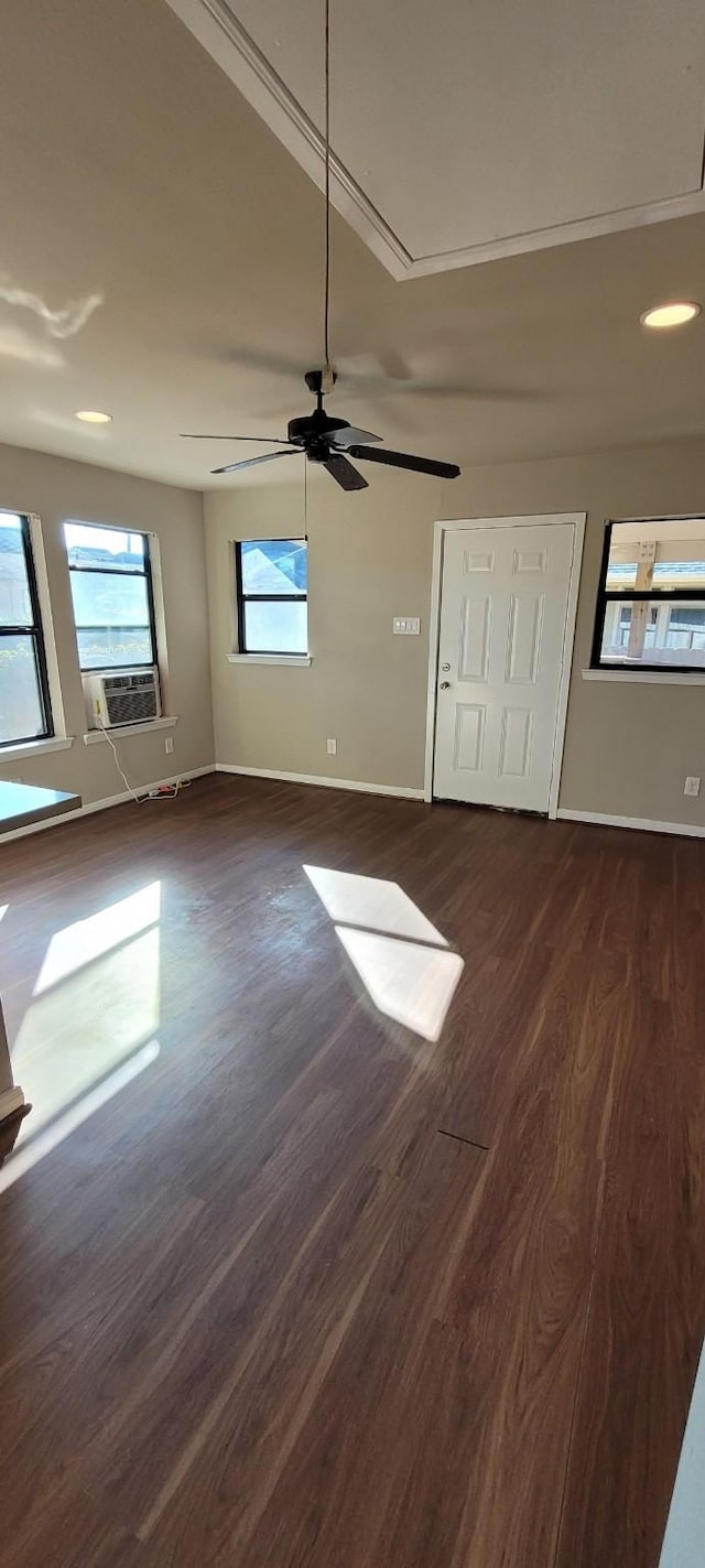 unfurnished bedroom with dark hardwood / wood-style flooring, cooling unit, and ceiling fan