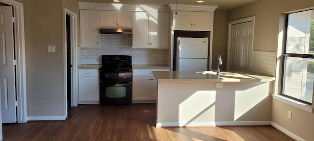 kitchen with black range with electric cooktop, white refrigerator, dark hardwood / wood-style floors, and white cabinetry