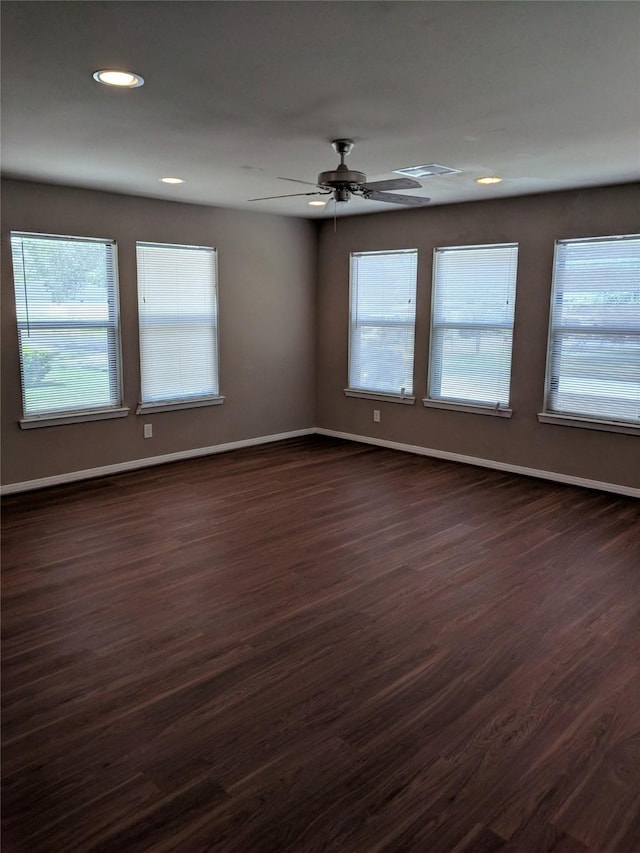 empty room featuring dark hardwood / wood-style floors and ceiling fan