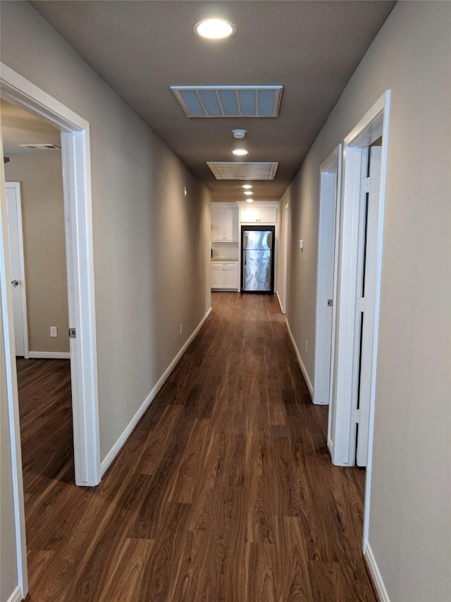 hall with dark hardwood / wood-style flooring