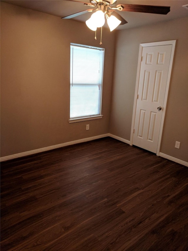 unfurnished room with dark wood-type flooring