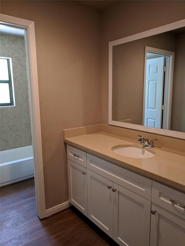 bathroom featuring hardwood / wood-style flooring and vanity