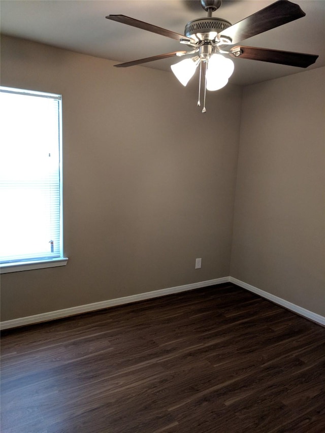 empty room featuring ceiling fan and dark hardwood / wood-style flooring